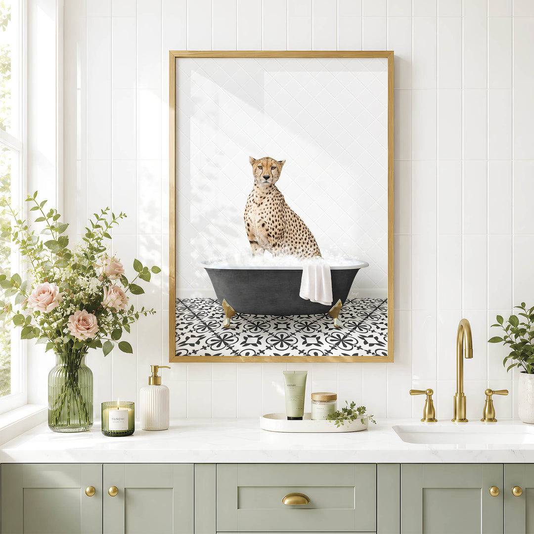 A framed image of a cheetah sitting in a bathtub, surrounded by a vase of flowers, candles, and a potted plant, all set against a white tiled wall.