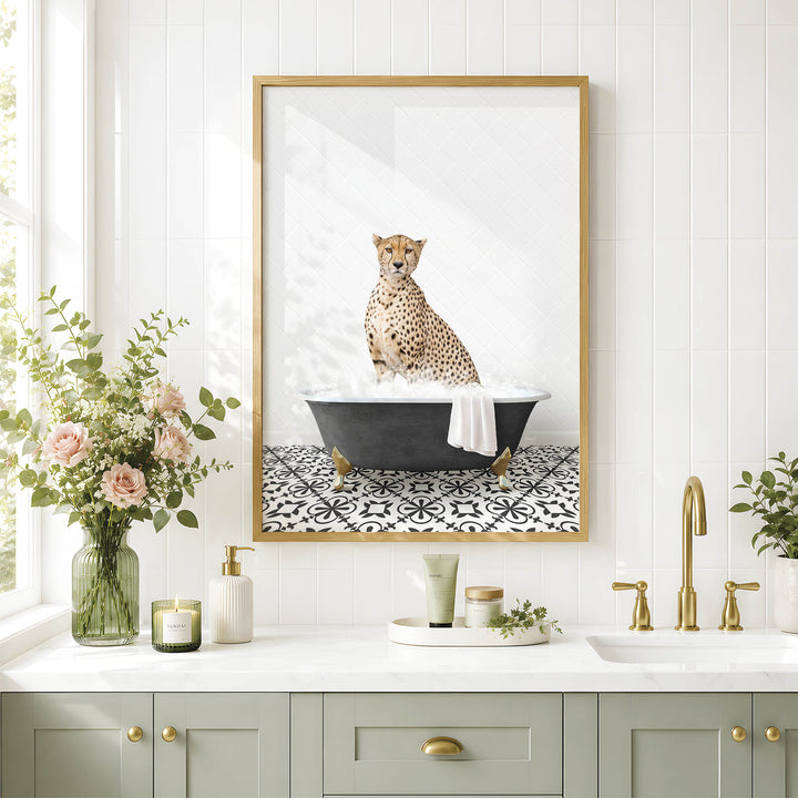 A framed image of a cheetah sitting in a bathtub, surrounded by a vase of flowers, candles, and a potted plant, all set against a white tiled wall.