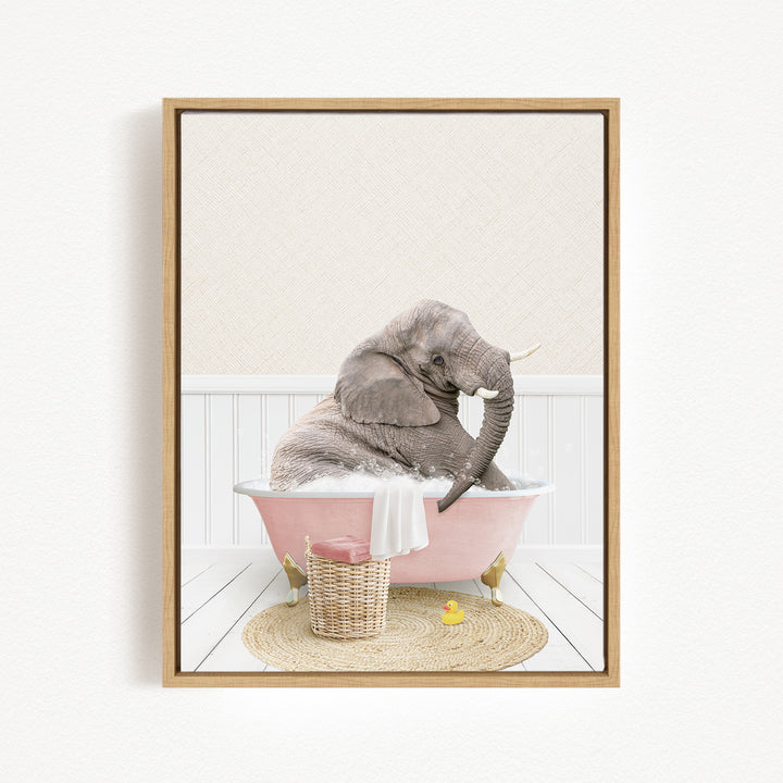 A gray elephant is sitting in a pink bathtub, surrounded by a basket of toys and a yellow rubber ducky, creating a whimsical and playful scene.