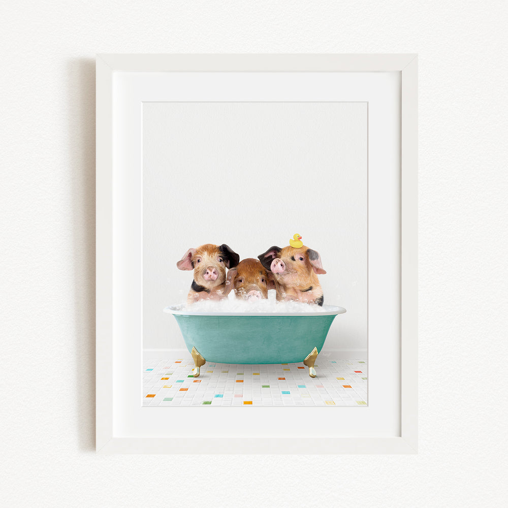Three adorable pigs sitting in a green bathtub, with one of them wearing a yellow hat.