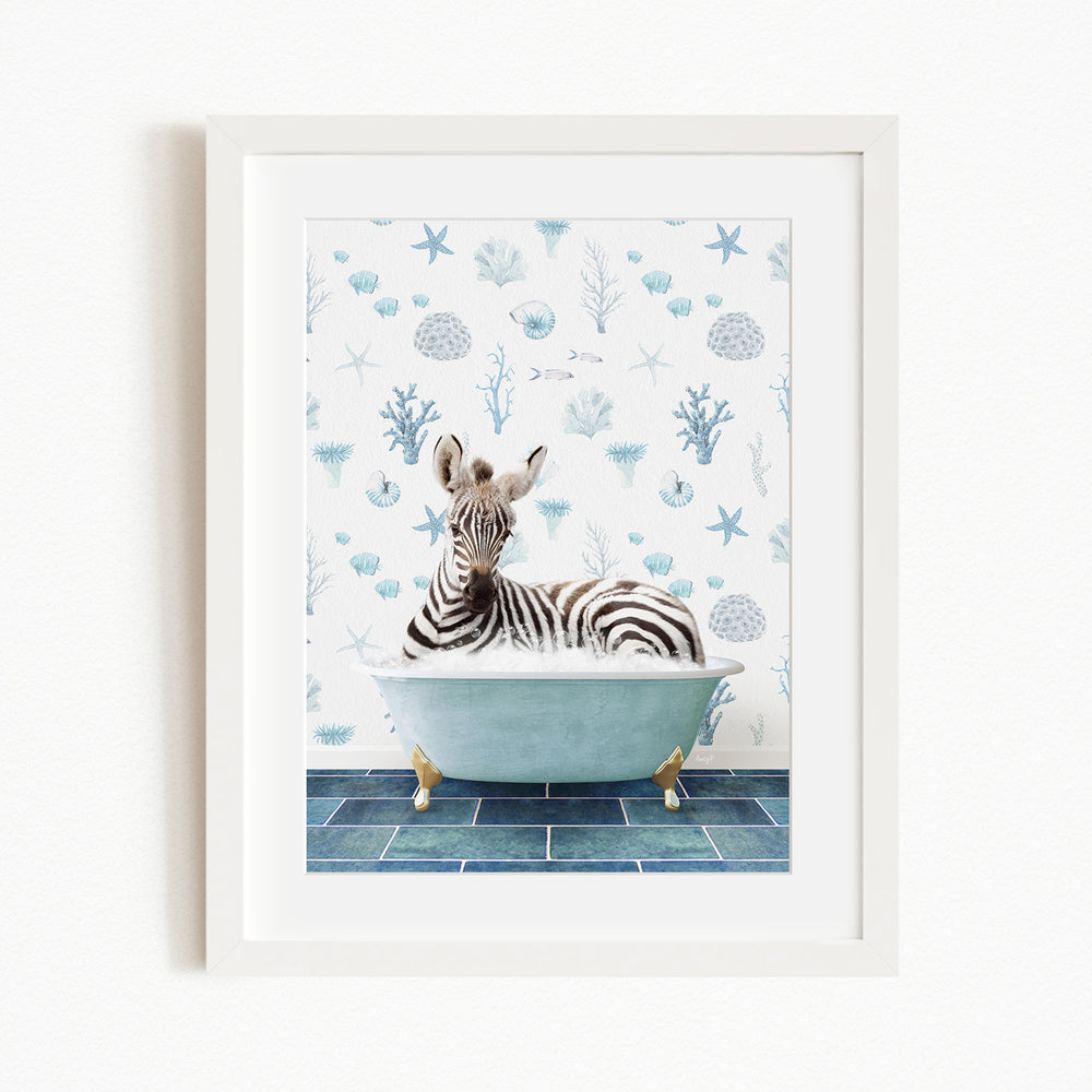 A zebra is sitting in a bathtub filled with water, surrounded by a blue and white ocean-themed wallpaper.