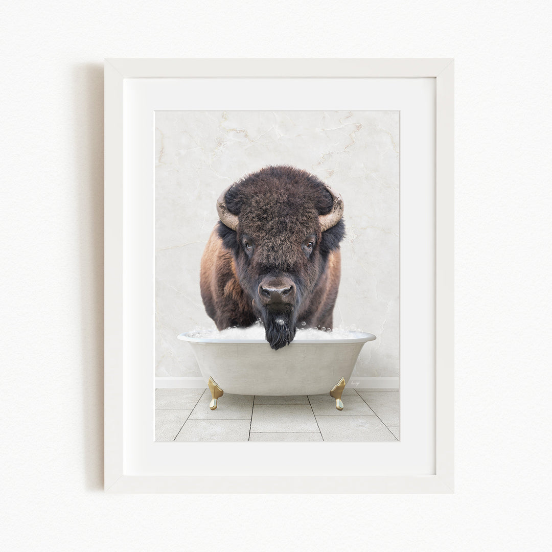 A buffalo with large horns is standing in a white bathtub filled with water, appearing to be enjoying a bath.