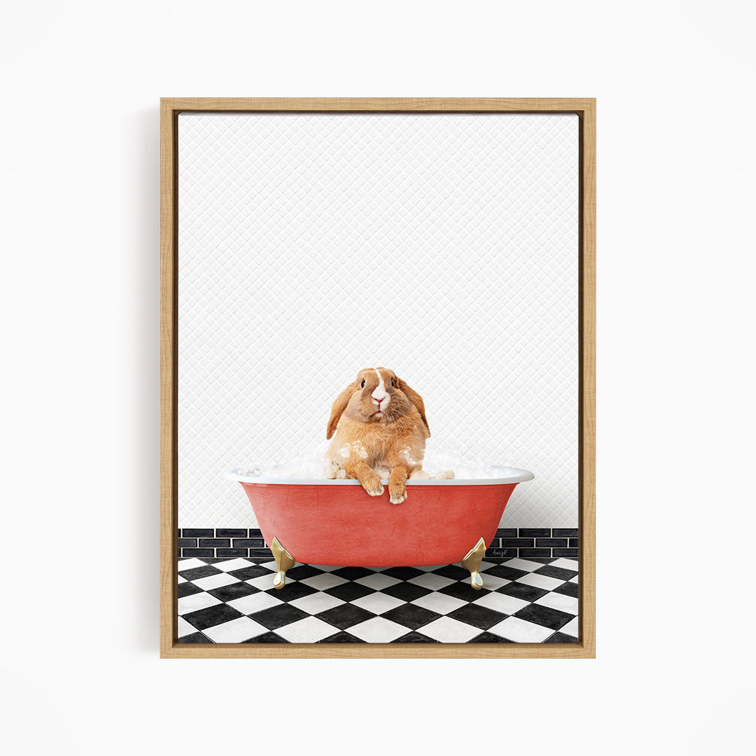 A brown rabbit sitting in a red bathtub filled with bubbles, surrounded by a black and white checkered floor.