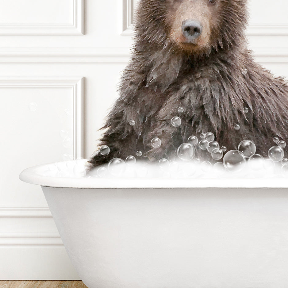 a brown bear sitting in a bathtub filled with bubbles