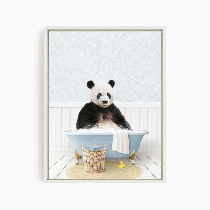 A panda bear sitting in a blue bathtub, surrounded by a yellow rubber duck and a basket.