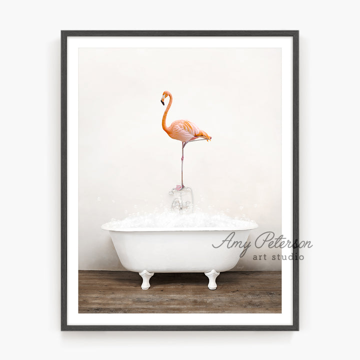 a pink flamingo standing on top of a bathtub