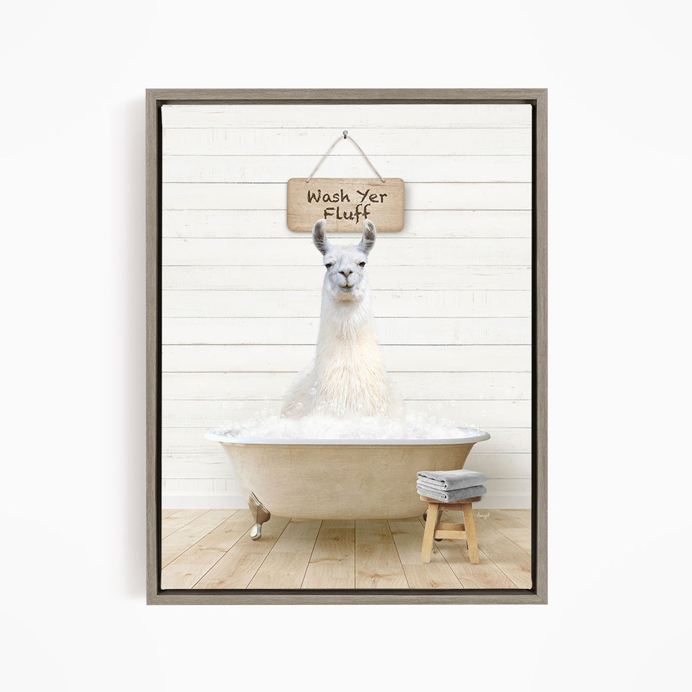 A white llama sitting in a bathtub, with a wooden sign above it that says "Wash Yer Fluff".