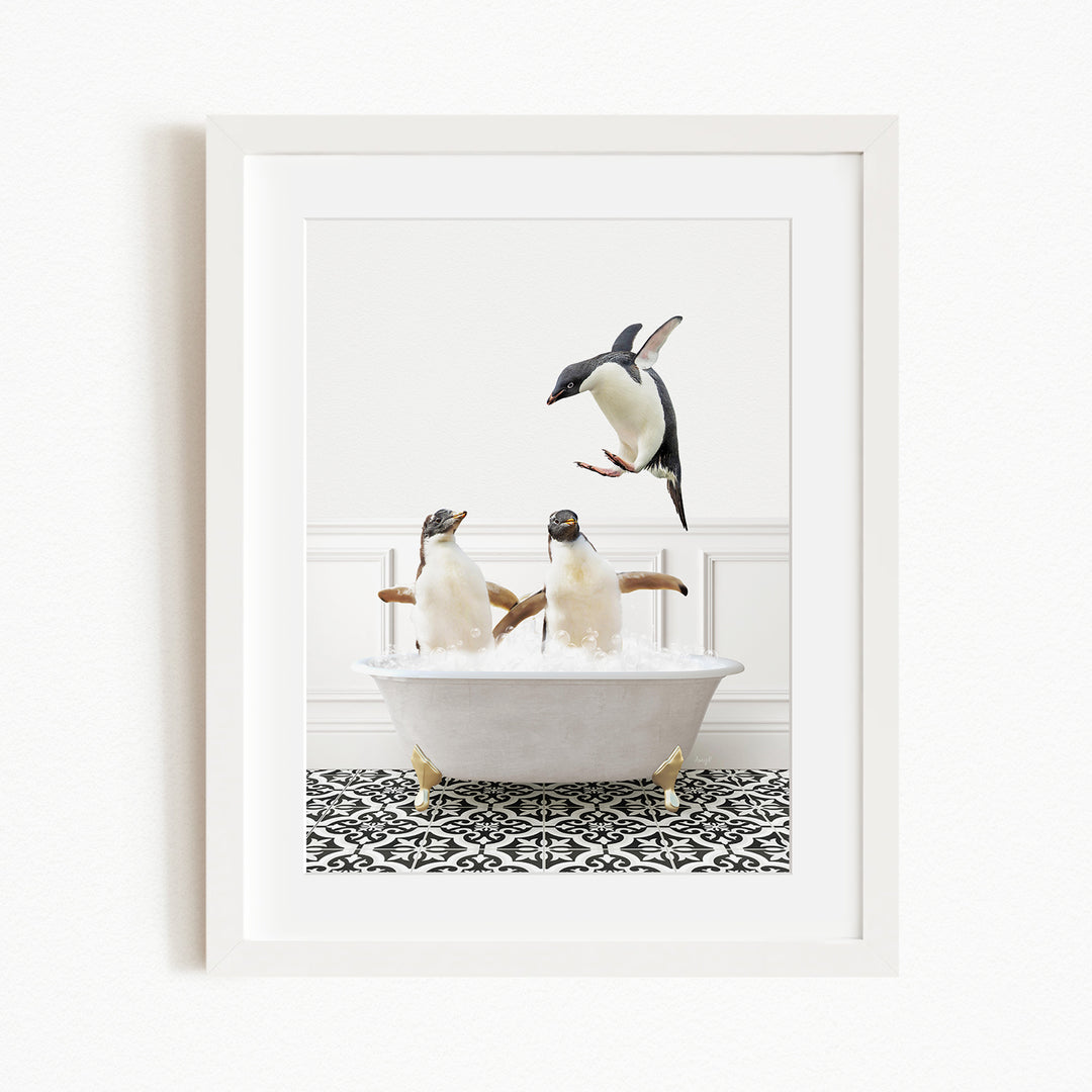 A framed image depicting two penguins sitting in a bathtub, with one penguin flying towards the other penguin.
