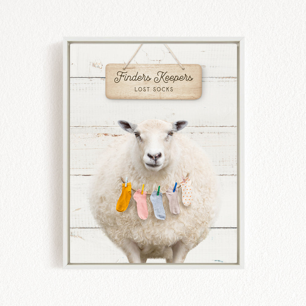 A white sheep with a sign that says "Finders Keepers" and "Lost Socks" hanging above it.