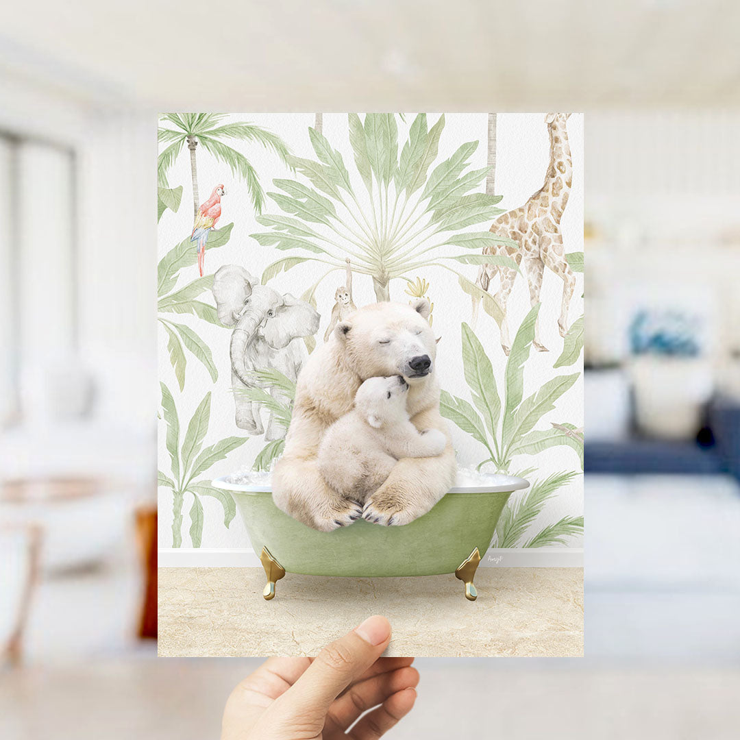 A hand holds up a framed print featuring a polar bear sitting in a bathtub surrounded by tropical plants and animals, including a giraffe and elephant.