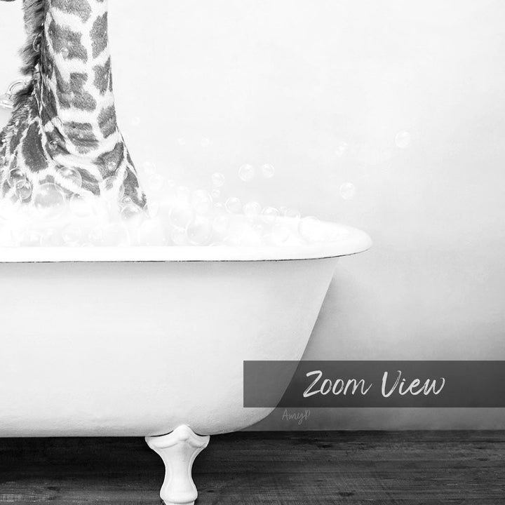 A close-up black and white image of a giraffe standing in a bathtub filled with bubbles.