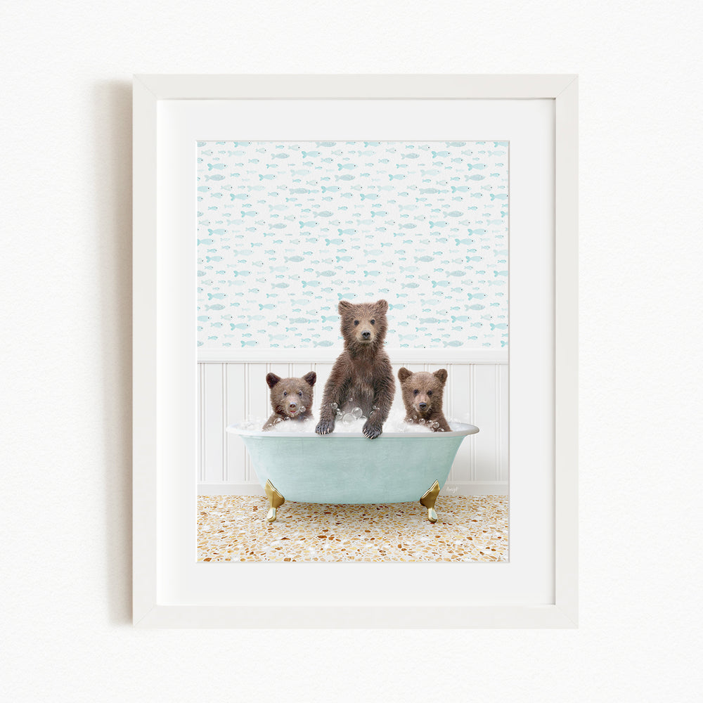 Three adorable brown bears sitting in a light blue bathtub, with a patterned wallpaper in the background.