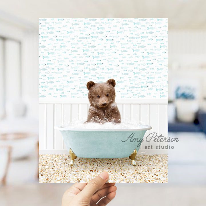 a small teddy bear sitting in a bath tub