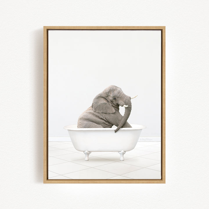 A gray elephant sitting in a white bathtub, with its trunk raised and appearing to be enjoying the bath.