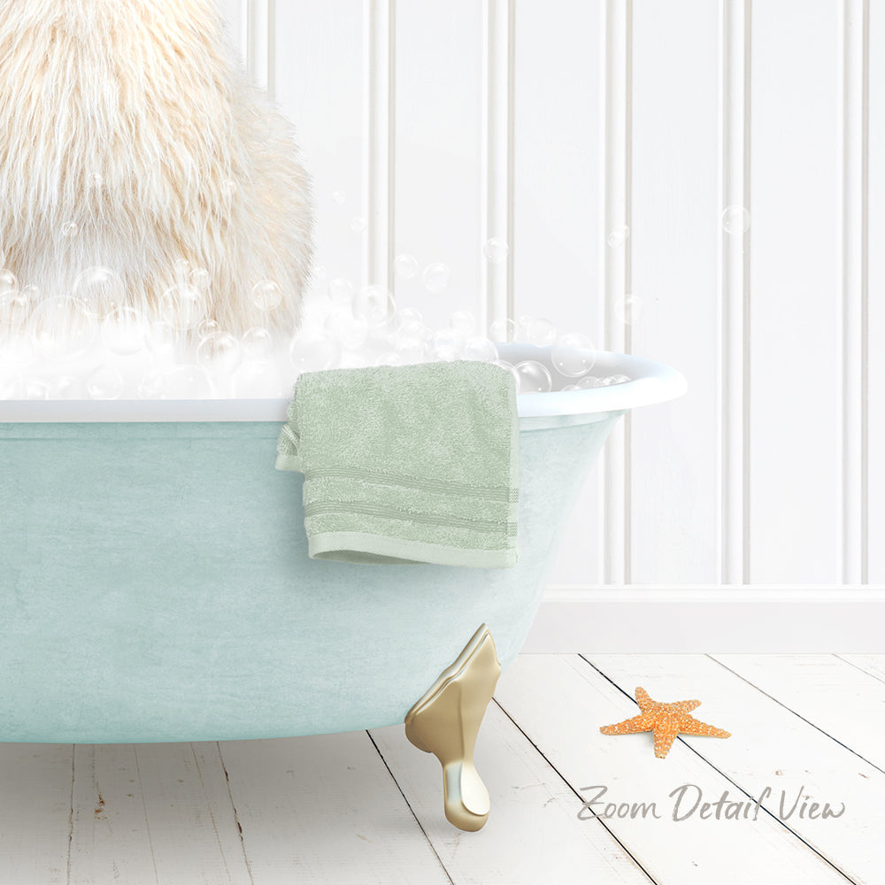 A fluffy white cat is sitting in a light blue bathtub filled with bubbles, with a green towel hanging on the side and a starfish on the floor next to the tub.