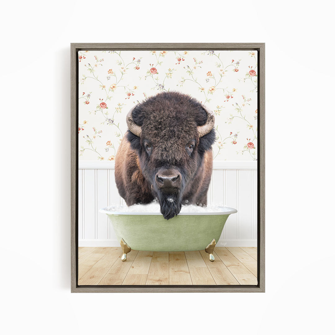 A buffalo with a long, shaggy mane is standing in a green bathtub, with a floral wallpaper in the background.