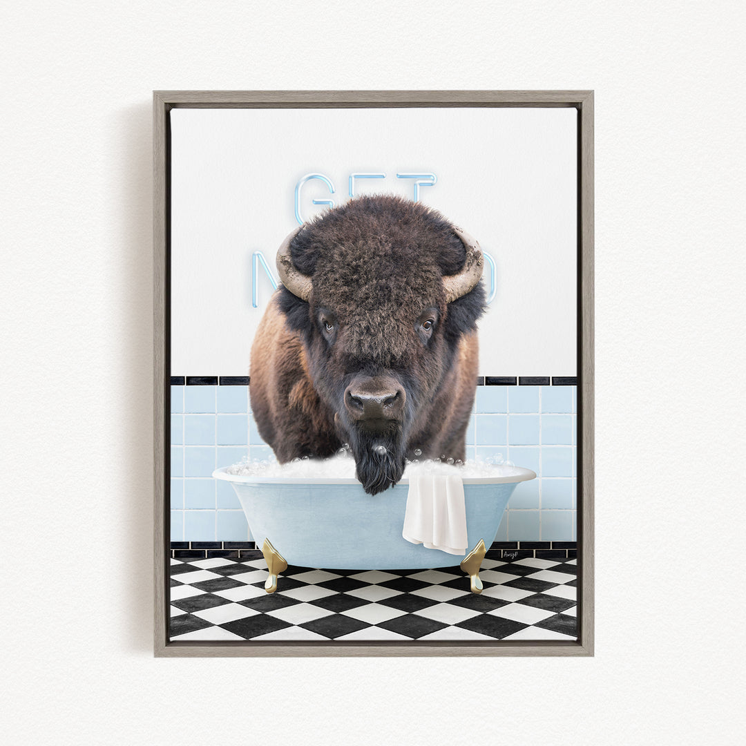 A buffalo is sitting in a bathtub filled with water, with a towel draped over the side of the tub.