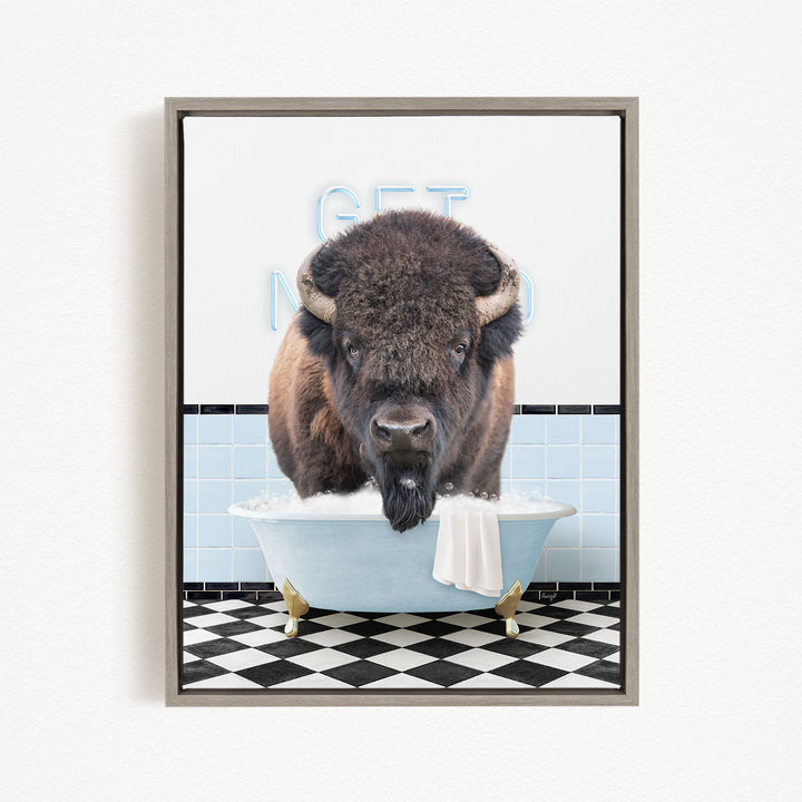A buffalo is sitting in a bathtub filled with water, with a towel draped over the side of the tub.