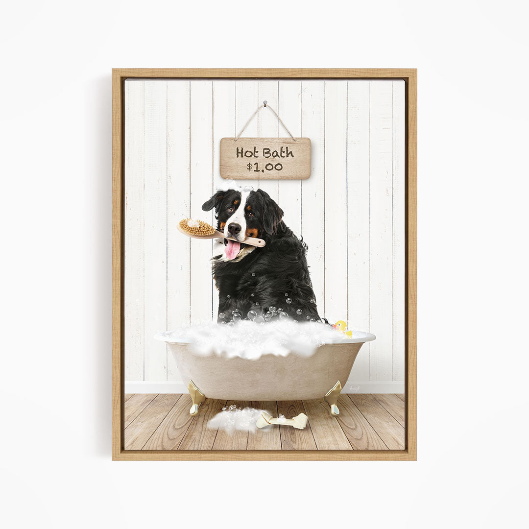 A black and white dog is sitting in a white bathtub filled with bubbles, holding a toy in its mouth, and there is a sign above the bathtub that says "Hot Bath $1.00".