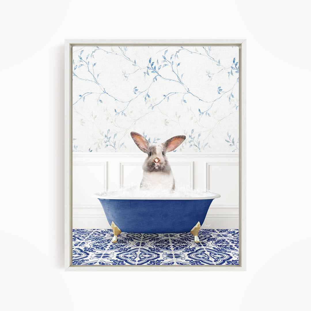 A white rabbit sitting in a blue bathtub filled with water, with a patterned tile floor in the background.
