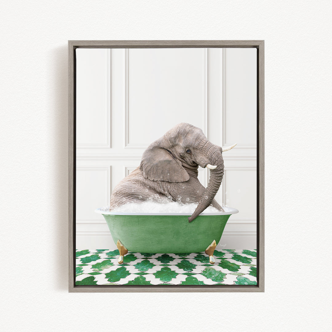 A gray elephant is sitting in a green bathtub filled with water, surrounded by a green and white patterned mat.