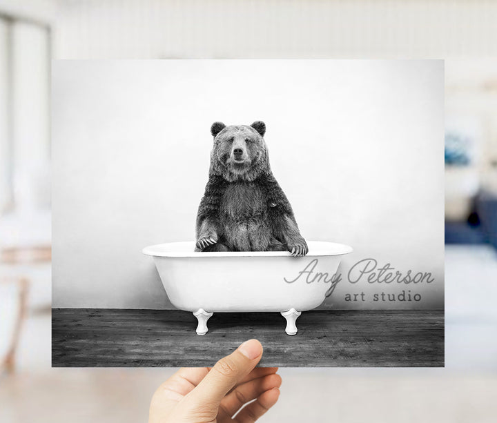 a black and white photo of a bear in a bathtub