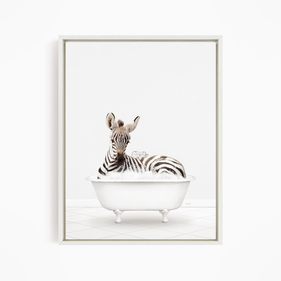 A zebra is sitting in a white bathtub filled with water, creating a whimsical and playful scene.