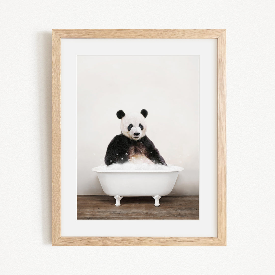 A panda bear sitting in a white bathtub filled with bubbles, creating a whimsical and playful scene.
