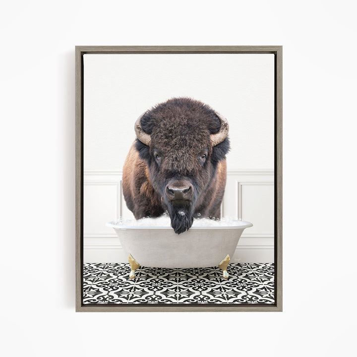 A buffalo with large horns is standing in a white bathtub filled with water, creating a humorous and unexpected scene.