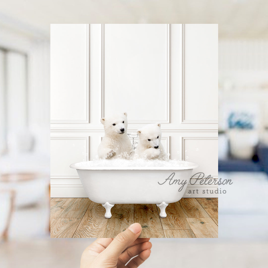 two small white dogs sitting in a bathtub