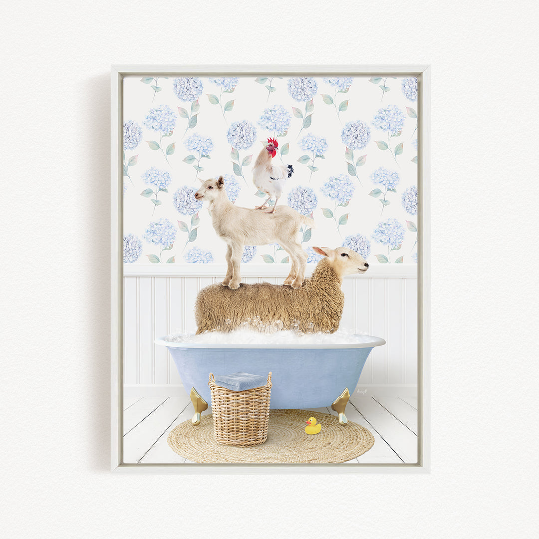 A framed image depicting a sheep standing on a tub filled with water, with a chicken perched on top of it, and a lamb sitting on the tub's edge. The background features a floral pattern.