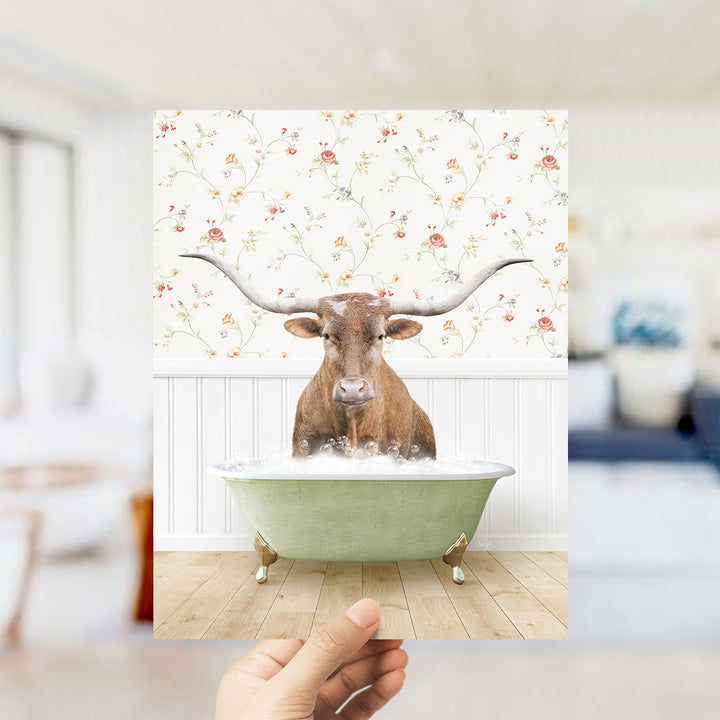 A brown cow with large horns is sitting in a green bathtub filled with water, creating a whimsical and humorous scene.