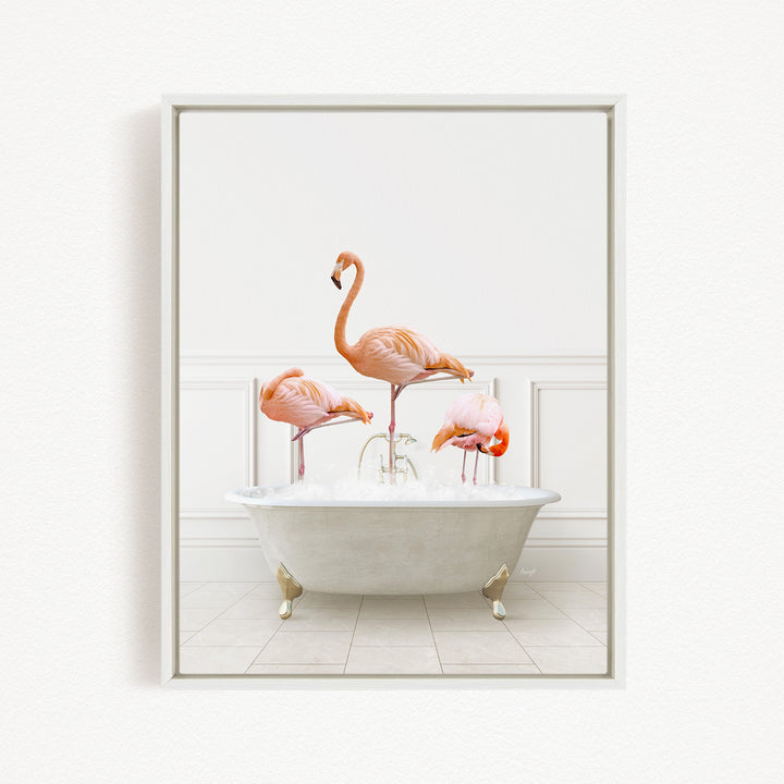 A framed image depicting three pink flamingos standing in a white bathtub filled with water.