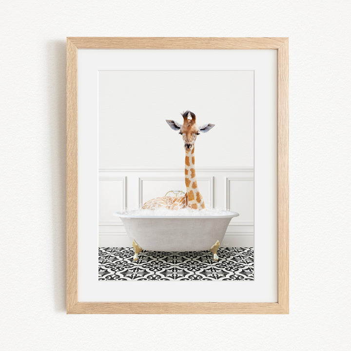 A giraffe is sitting in a white bathtub filled with bubbles, creating a whimsical and playful scene.