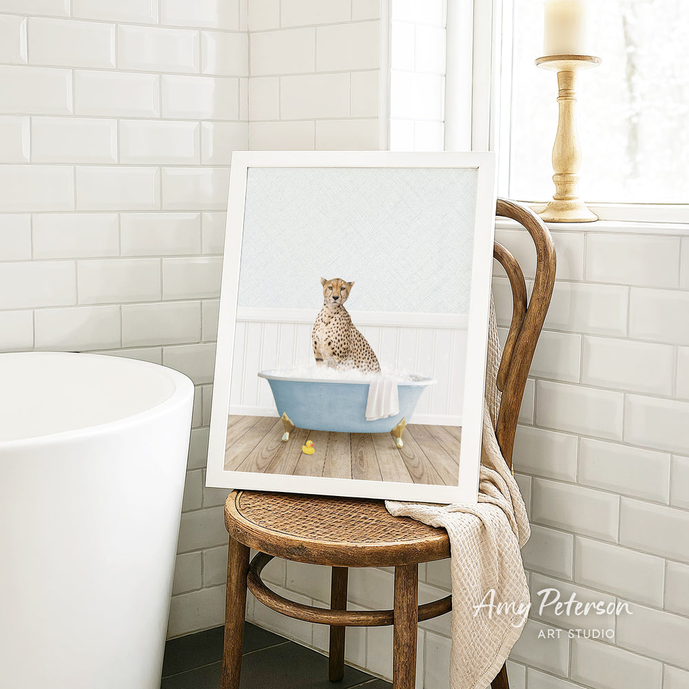 A cheetah sitting in a blue bathtub, surrounded by white tiles, in a bathroom setting.