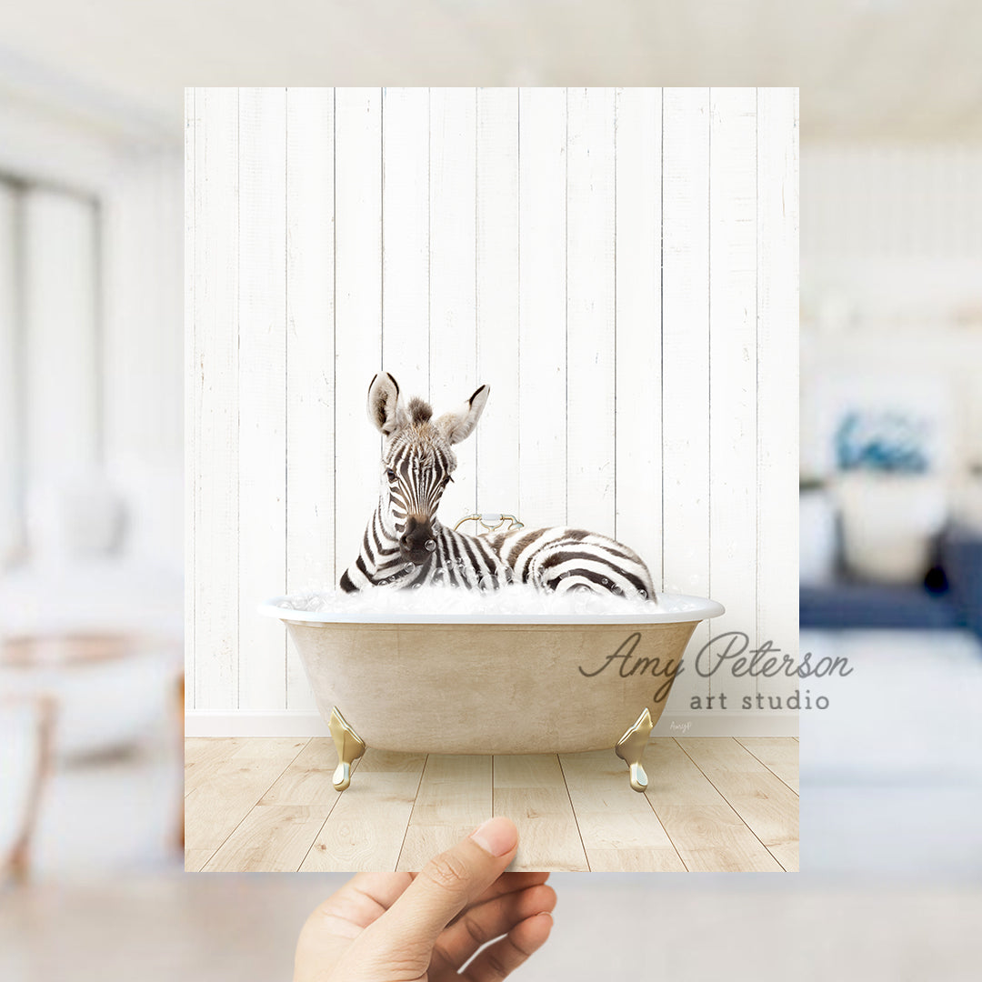 a hand holding a photo of a zebra in a bathtub