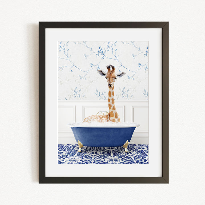A giraffe is sitting in a blue bathtub, surrounded by a patterned tile floor and a white wall with blue floral wallpaper.
