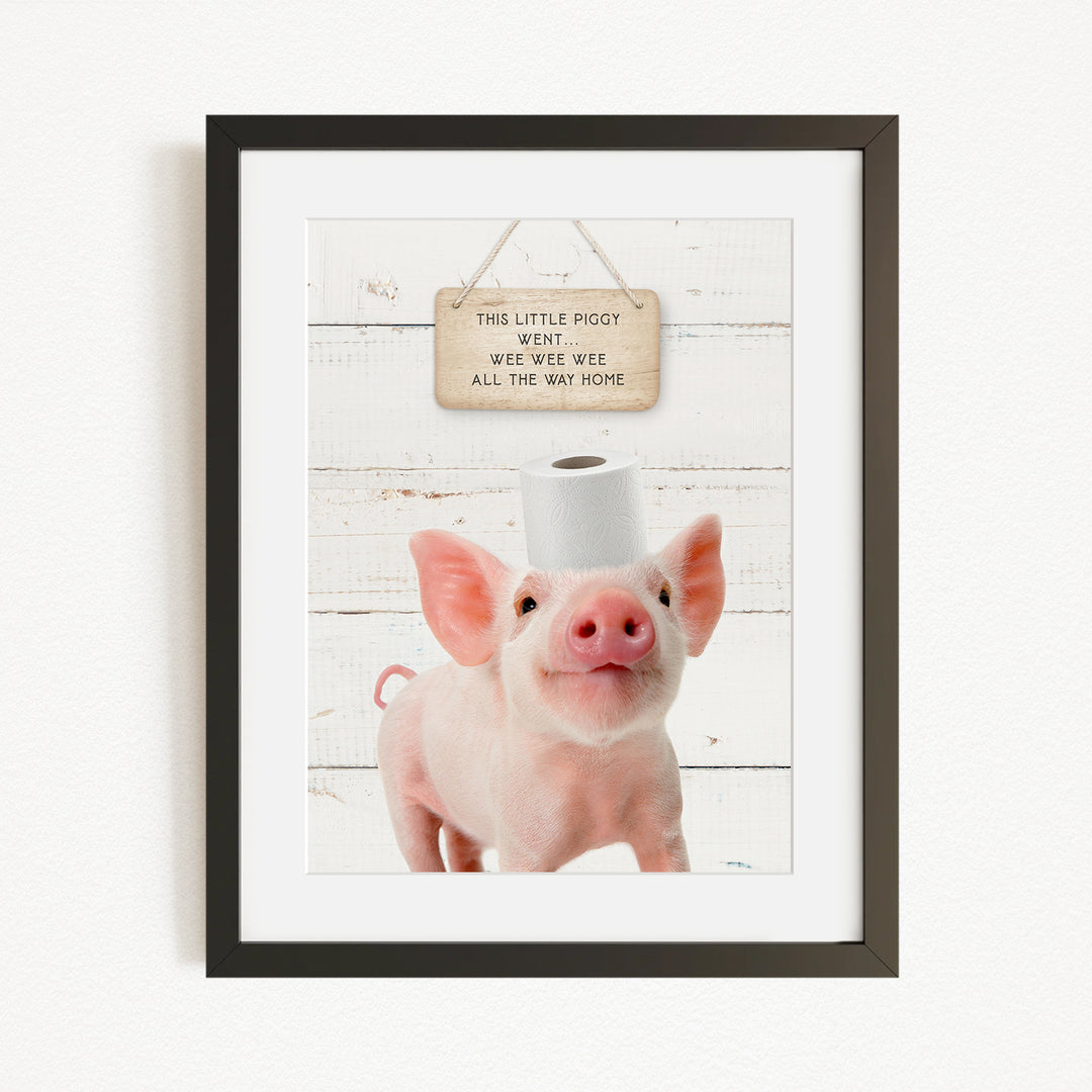 A framed image of a pig with a sign above it that reads "This little piggy went witee witee all the way home".
