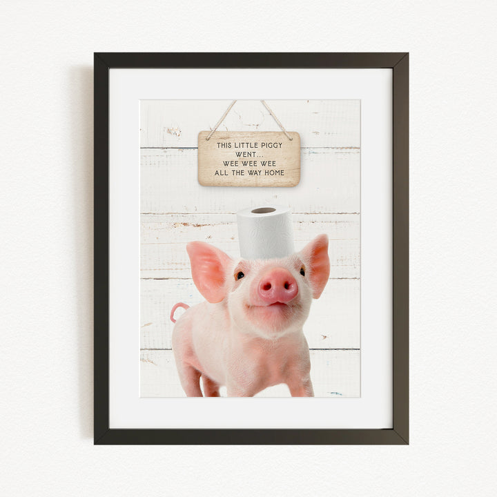 A framed image of a pig with a sign above it that reads "This little piggy went witee witee all the way home".