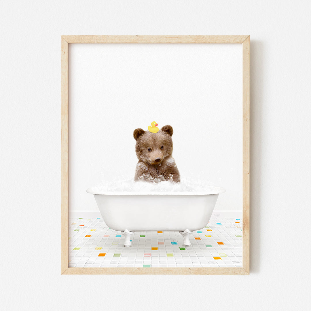 a framed photograph of a teddy bear in a bathtub