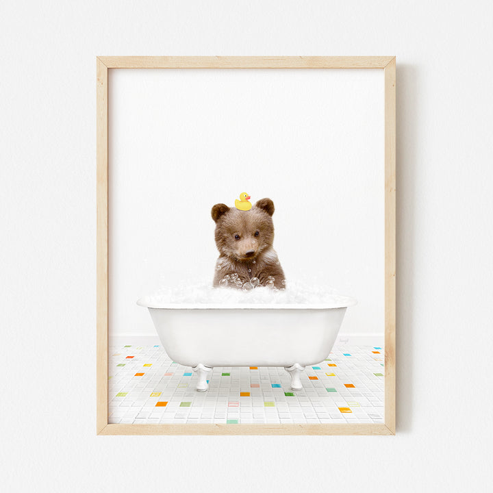 a framed photograph of a teddy bear in a bathtub