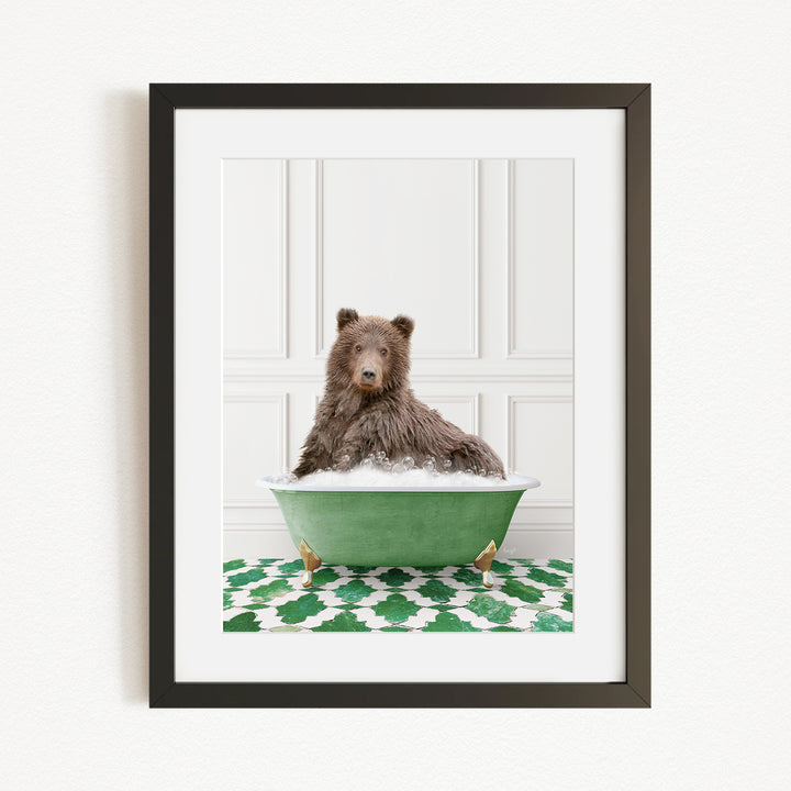 A brown bear sitting in a green bathtub filled with water, surrounded by a green and white patterned rug.