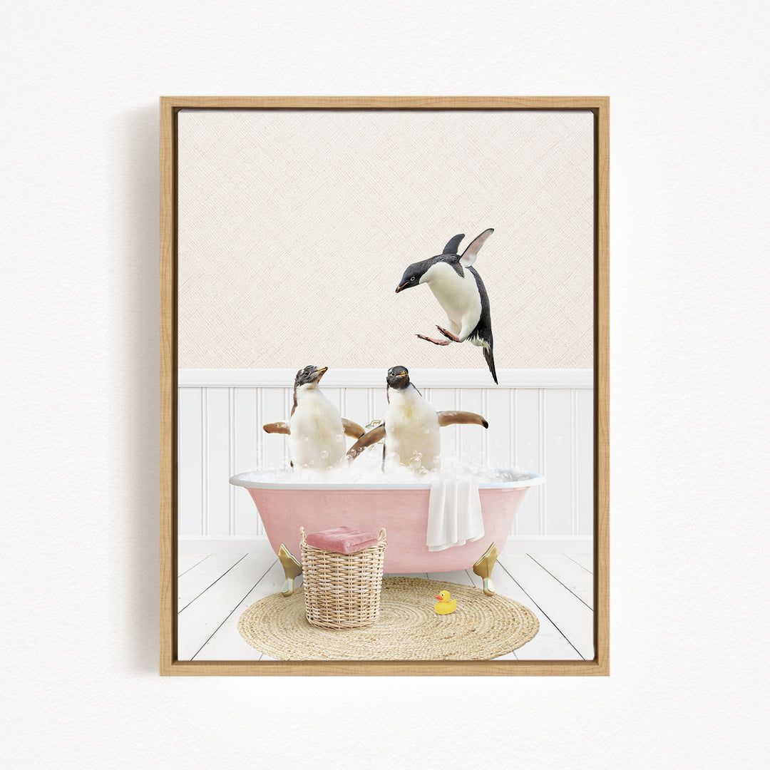 A framed image depicting two penguins sitting in a pink bathtub, with one penguin flying towards the other.