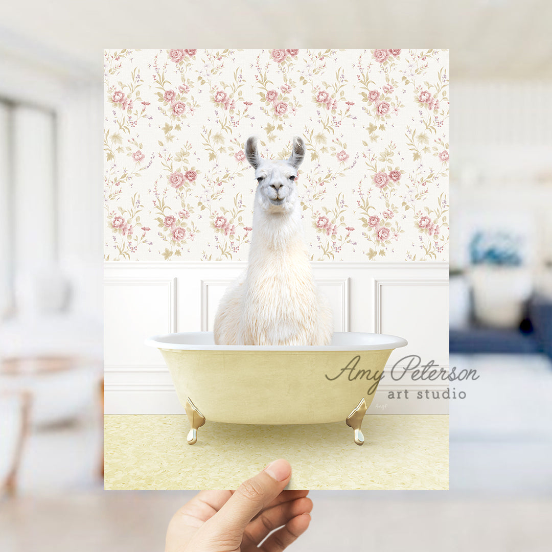 a hand holding a card with a llama in a bathtub