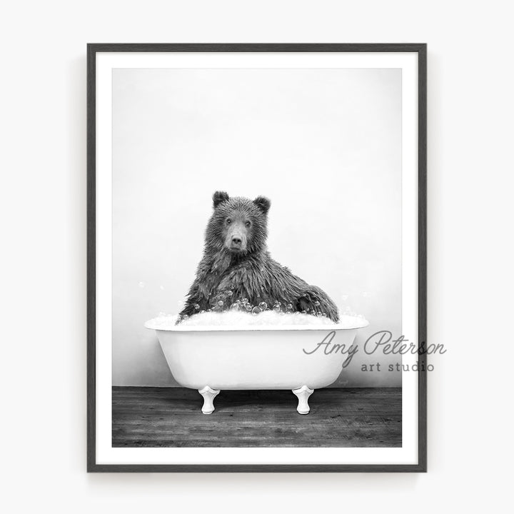 a black and white photo of a bear in a bathtub