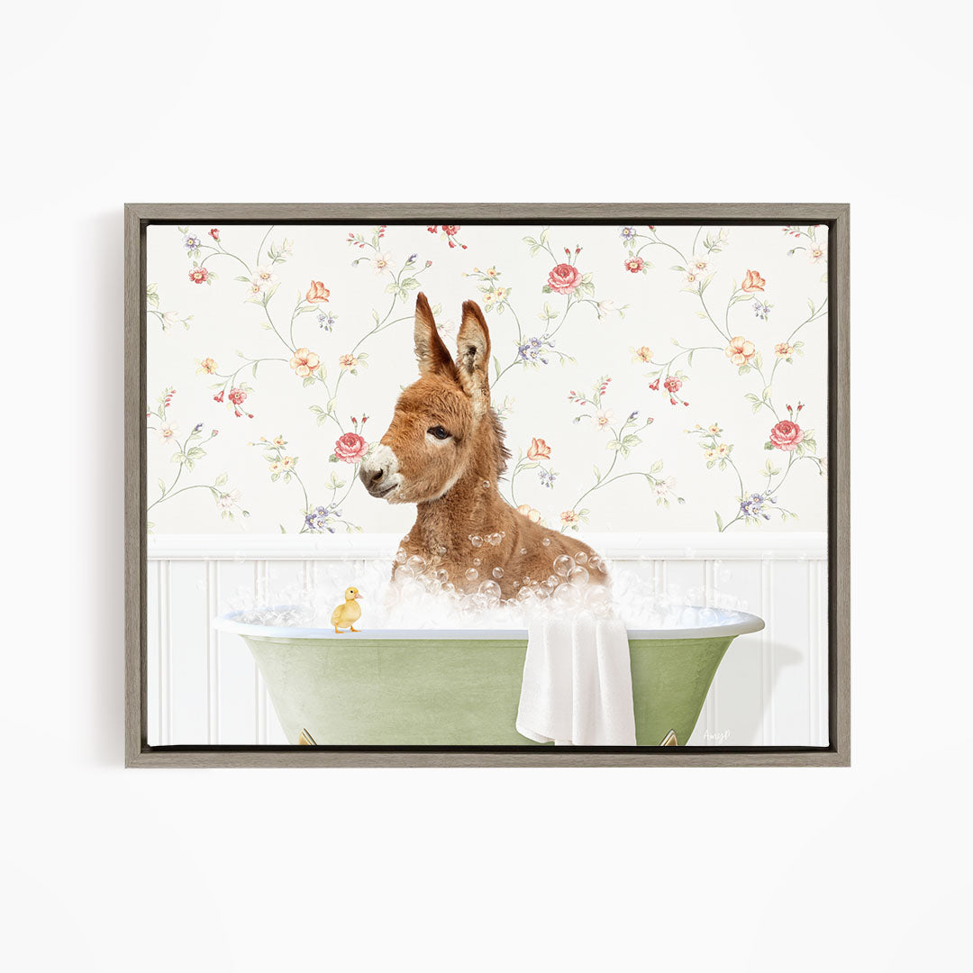 A brown donkey is sitting in a green bathtub filled with water, surrounded by a floral wallpaper.