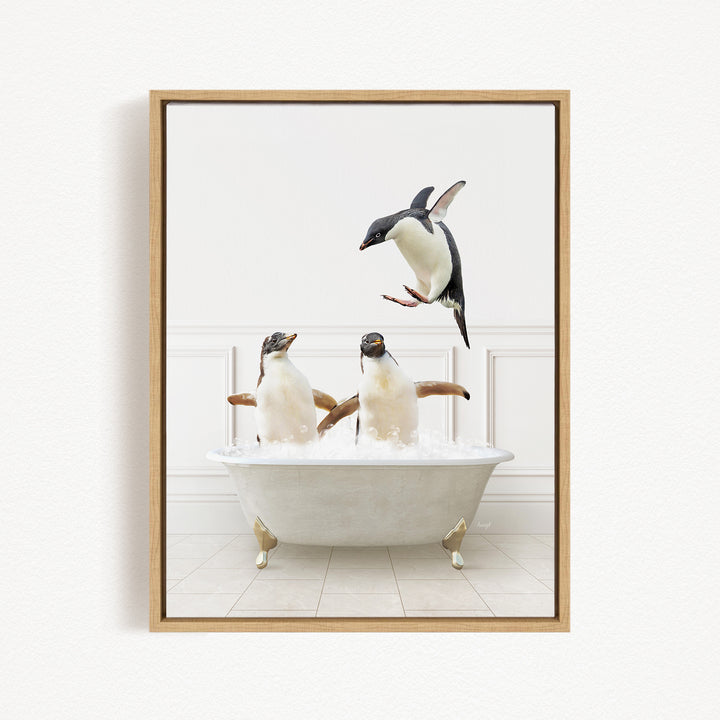 A framed image depicting three penguins in a bathtub, with one penguin flying above the tub.