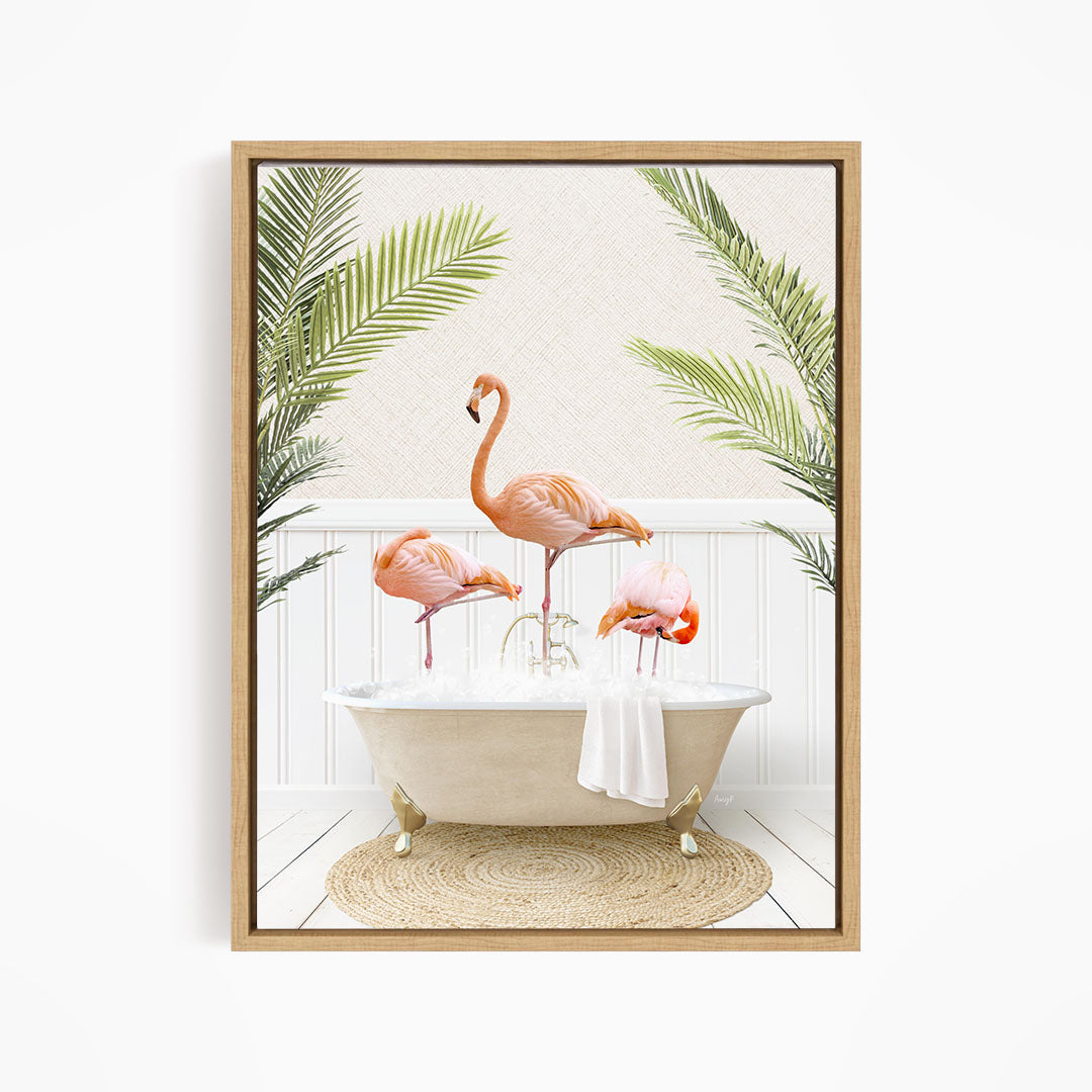 A framed image depicting three pink flamingos standing in a white bathtub, surrounded by green palm leaves.