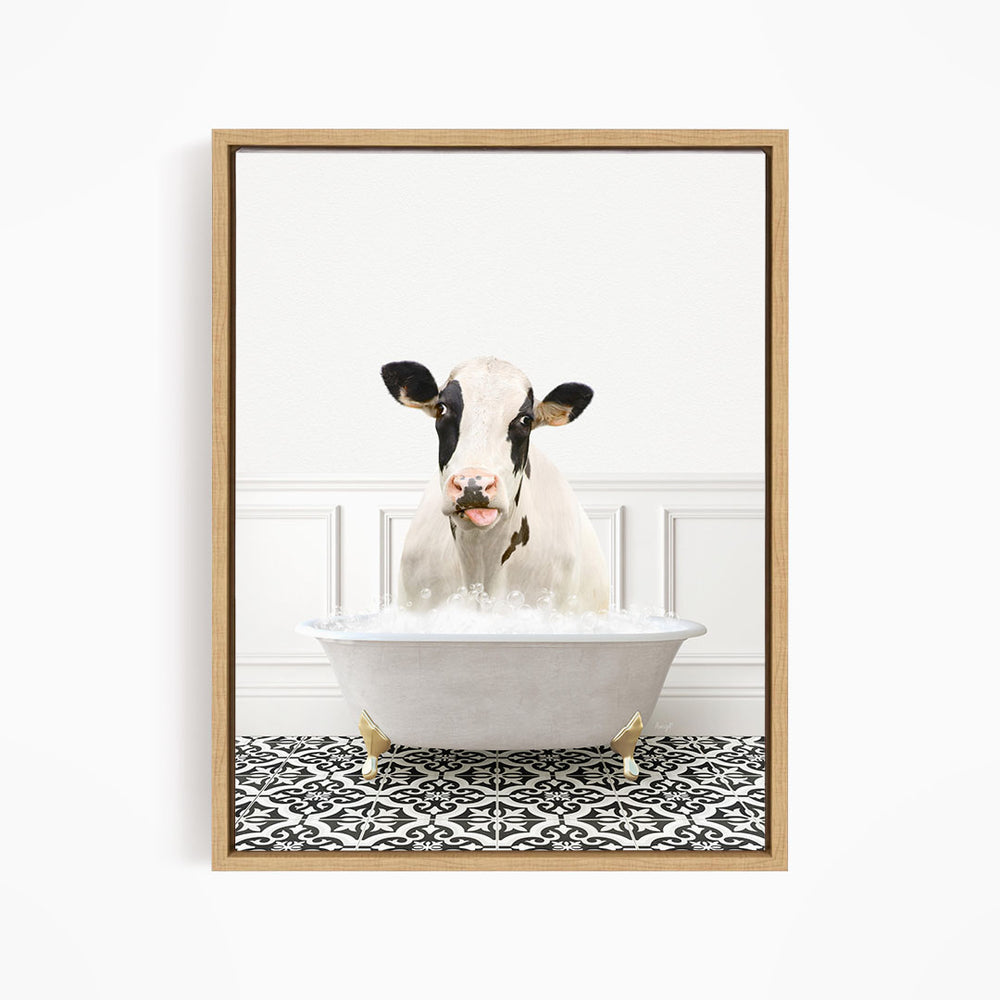 A black and white cow is sitting in a white bathtub filled with bubbles, creating a whimsical and humorous scene.