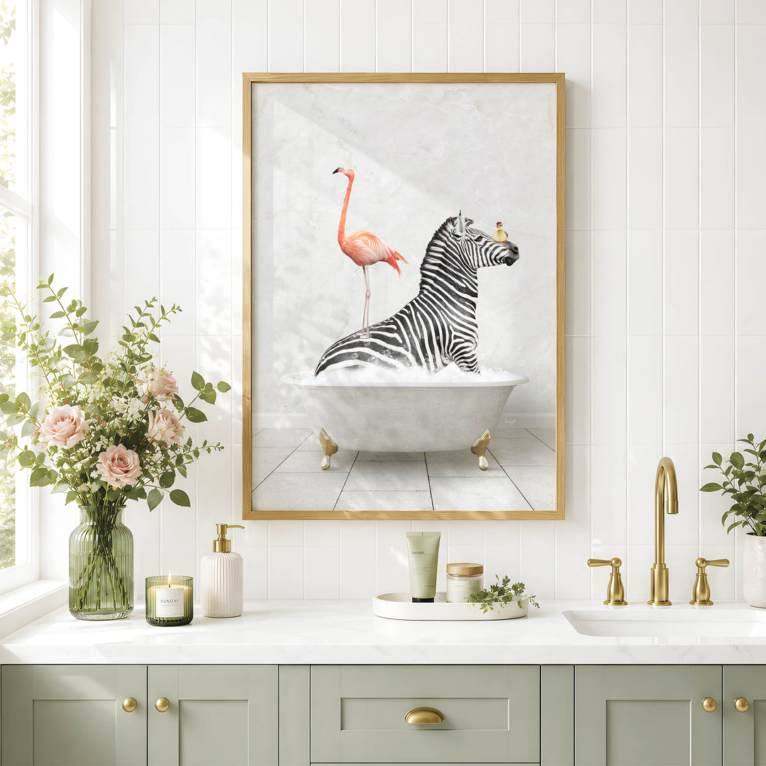 a bathroom with a framed picture of a zebra sitting in a bathtub, surrounded by pink flamingos. The bathroom has a white countertop, a sink, and a vase of flowers.